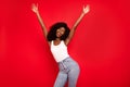 Photo of young excited african girl happy positive smile have fun enjoy hands up music dance isolated over red color Royalty Free Stock Photo