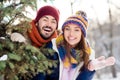 Photo of young excited couple happy positive smile have fun enjoy time together winter vacation forest woods
