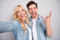 Photo of young excited couple happy positive smile show fingers rock horns sign take selfie  over grey color Royalty Free Stock Photo