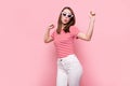 Photo of young excited girl happy positive smile have fun dance wear sunglass isolated over pink color background Royalty Free Stock Photo