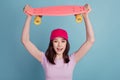 Photo of young excited girl happy positive smile hold skateboard rider sport isolated turquoise color background