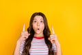 Photo of young excited girl look indicate fingers up advert direct way suggest advice over yellow color