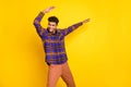 Photo of young excited man happy positive smile have fun enjoy dance look empty space isolated over yellow color Royalty Free Stock Photo