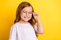 Photo of young excited small girl happy positive smile cheerful wear glasses isolated over yellow color background