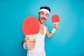 Photo of young excited sportive man happy smile play ping-pong hold racquet isolated over blue color background Royalty Free Stock Photo