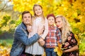 Photo of young family with children on walk in autumn park Royalty Free Stock Photo