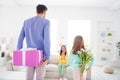 Photo of young family happy positive smile celebrate congrats mom birthday gift present flowers indoors Royalty Free Stock Photo