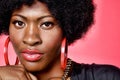 Portrait of young fashionista african american woman wearing red earrings