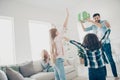 Photo of young foster family two children raising hands air receive unexpected giftbox glad to have best parents