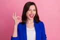 Photo of young funny blink eye flirty business woman wear blue blazer showing okey sign work done everything cool Royalty Free Stock Photo