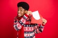 Photo of young funny brunet guy send letter wear holiday scarf sweater isolated on red color background