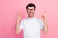 Photo of young funny crazy excited handsome man wear glasses pointing fingers up recommend good news isolated on pink Royalty Free Stock Photo