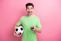 Photo of young funny guy click remote controller watching television football match support favorite team isolated on Royalty Free Stock Photo