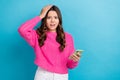 Photo of young funny stressed teen girl wear pink pullover touch head oops mistake hold phone hacked problems isolated Royalty Free Stock Photo