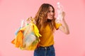 Photo of young furious woman holding bag with plastic waste and bottle