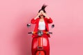 Photo of young girl amazed shocked surprised cover eyes hands open mouth sit bike isolated over pink color background Royalty Free Stock Photo