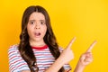 Photo of young girl amazed shocked surprised indicate fingers empty space advert decision promo over yellow