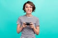 Photo of young girl bite lips teeth worried addicted play video game isolated over turquoise color background