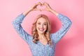 Photo of young girl blonde wavy hair wear blue trendy dress showing heart symbol fingers romantic day isolated on pink Royalty Free Stock Photo