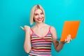 Photo of young girl bob haircut holding orange apple macbook directing finger mockup empty space message isolated on Royalty Free Stock Photo