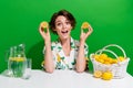 Photo of young girl culinary show slices lemon excited reaction demonstrate sour juice with water jug isolated on green Royalty Free Stock Photo