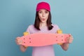 Photo of young girl excited skateboard rider headwear cool pouted lips isolated turquoise color background