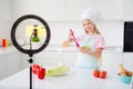 Photo of young girl happy positive smile cook salad vegetables ingredients lunch healthy food blogger make video indoors