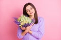 Photo of young girl happy positive smile enjoy present wildflowers isolated over pink color background