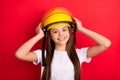 Photo of young girl happy positive smile hands touch helmet firewoman isolated over red color background