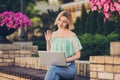 Photo of young girl happy positive smile sit park speak conversation video call laptop waving hello summer outdoors Royalty Free Stock Photo