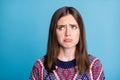 Photo of young girl happy unhappy sad upset moody look empty space isolated over blue color background