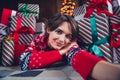 Photo of young girl lying floor gift make cute selfie wear trendy red sweater festive interior living room Royalty Free Stock Photo