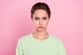 Photo of young girl pouted cheeks hold breath unhappy upset moody offended isolated over pink color background