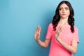 Photo of young girl show arms no stop reject symbol look empty space isolated over blue color background