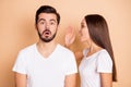 Photo of young girl tell say her amazed shocked surprised boyfriend secret gossip isolated over beige color background Royalty Free Stock Photo