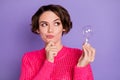 Photo of young girl think deep creative look empty space hand touch chin hold light bulb isolated over purple color