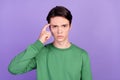 Photo of young guy finger touch head think memory accuse idiot blame isolated over violet color background