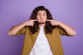 Photo of young guy fooling finger touch cheeks stupid hold breath comic isolated over purple color background