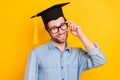 Photo of young guy happy positive smile master degree graduation university isolated over yellow color background