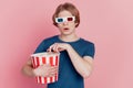 Photo of young guy hold popcorn paper box wear 3d glasses watch movie isolated pink color background