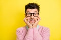 Photo of young handsome afraid scared shocked stressed man in glasses biting fingers isolated on yellow color background