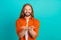 Photo of young handsome blond long hair man with mustache wear orange shirt asking christian church help isolated on Royalty Free Stock Photo