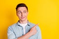 Photo of young handsome good looking dreamy guy look copyspace advertise product isolated on yellow color background Royalty Free Stock Photo