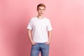 Photo of young handsome man confident arms in pocket wear casual outfit isolated over pink color background