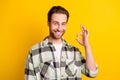 Photo of young handsome man happy positive smile show okay alright great sign ad isolated over yellow color background
