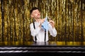 Photo of young handsome man serious concentrated focused clean glass bartender work isolated over glitter color Royalty Free Stock Photo