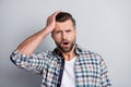 Photo of young handsome shocked unhappy stressed man made a mistake hold hand head isolated on grey color background