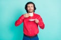 Photo of young handsome smiling dreamy man smell coffee having break relaxing isolated on turquoise color background Royalty Free Stock Photo