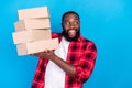 Photo of young happy afro american dreamy man hold hands boxes move relocation isolated on blue color background