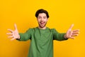 Photo of young happy amazed cheerful man open hands you welcome smile isolated on yellow color background Royalty Free Stock Photo